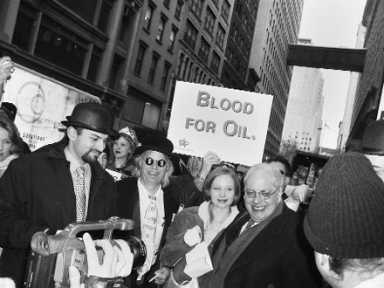 Black and white image of a crowd of people, with one person holding a sign that reads "Blood for Oil."