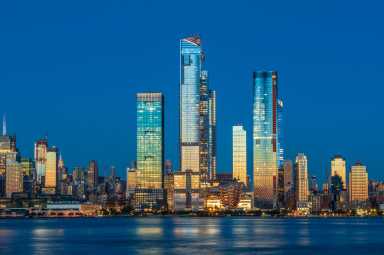 View to Manhattan skyline from Weehawken Waterfront in  Hudson River at sunset.