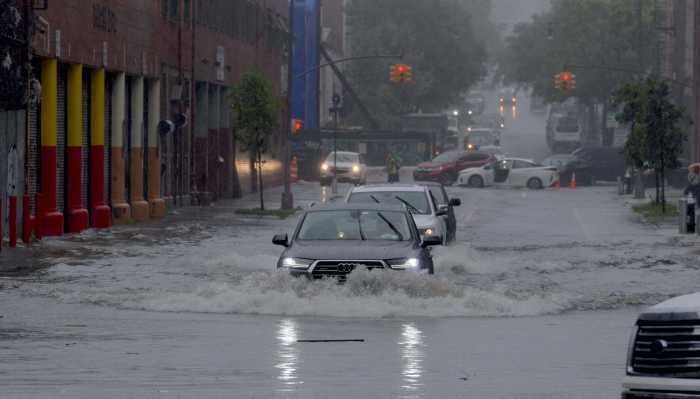 SEE IT: Driving rains, high winds from Fay flood New York streets, topple trees 4