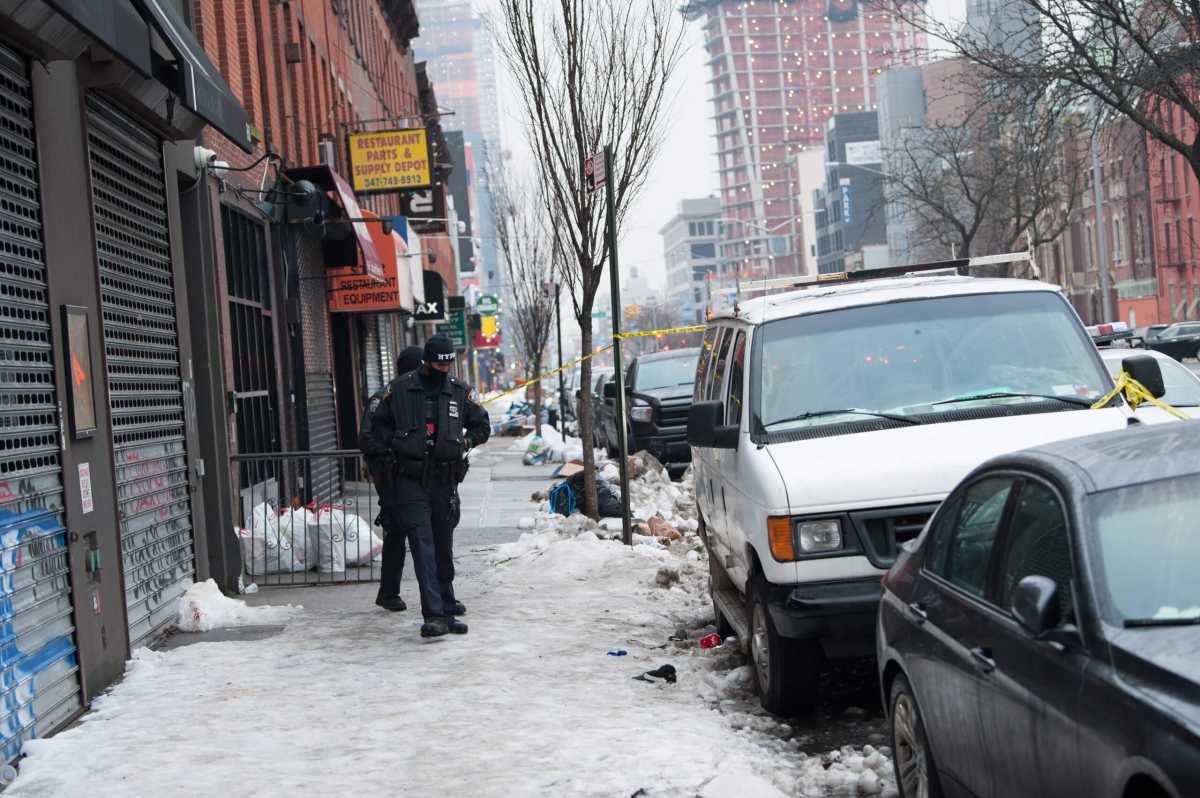 Officers from the 77th Precinct probe