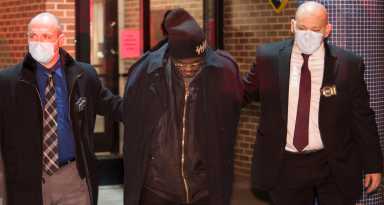 Brooklyn murder suspect Kevin Gavins, 66, is walked out of the 73rd Precinct by detectives on Jan. 21, 2021.