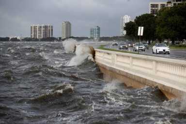 Waves crash the balustrades on Bayshore Boulevard after Hurricane Elsa churns up the Gulf coast, in Tampa