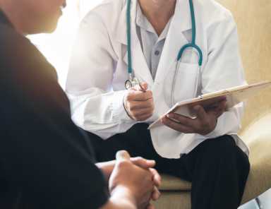 Men’s health exam with doctor or psychiatrist working with patient having consultation on diagnostic examination on male disease or mental illness in medical clinic or hospital mental health service