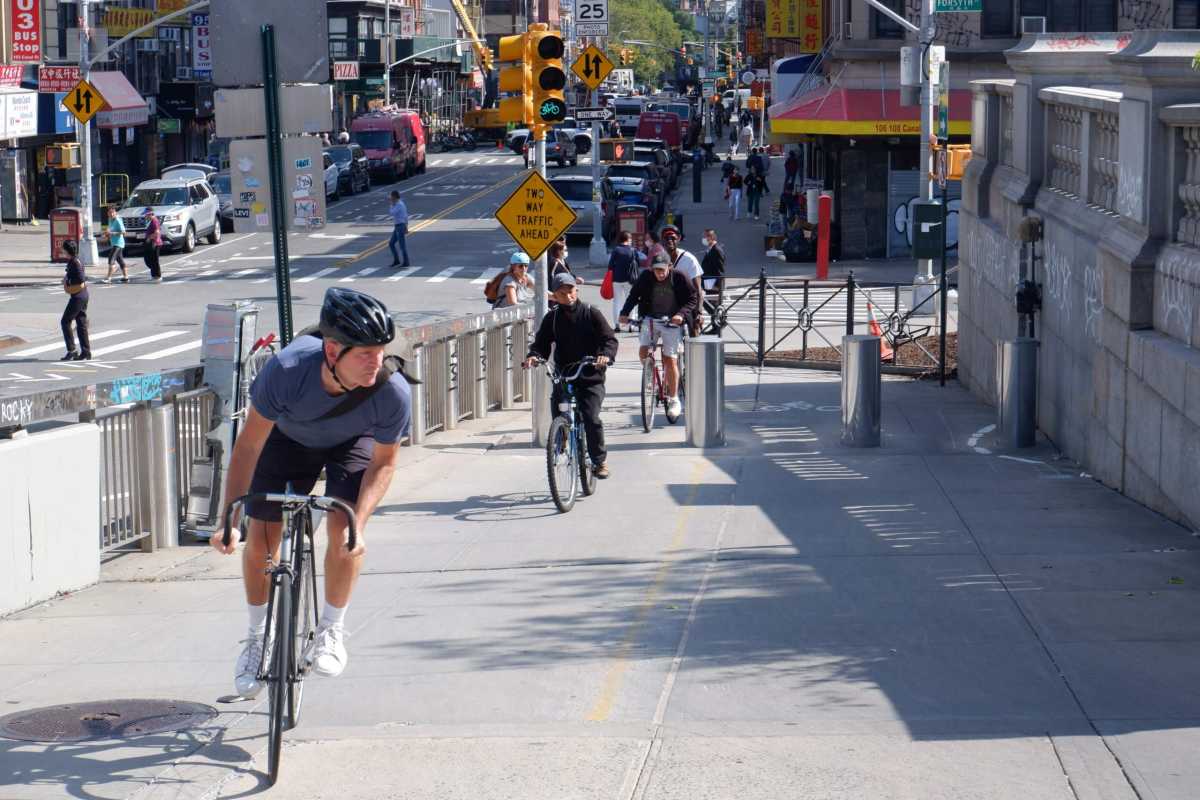 Cyclists approach the Manhattan Bridge bike lane in Chinatown.