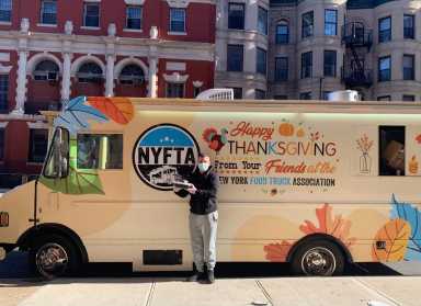 Eddie Goldstin, a member of the New York Food Truck Association, hands out Thanksgiving meals outside of a homeless shelter in Brooklyn.