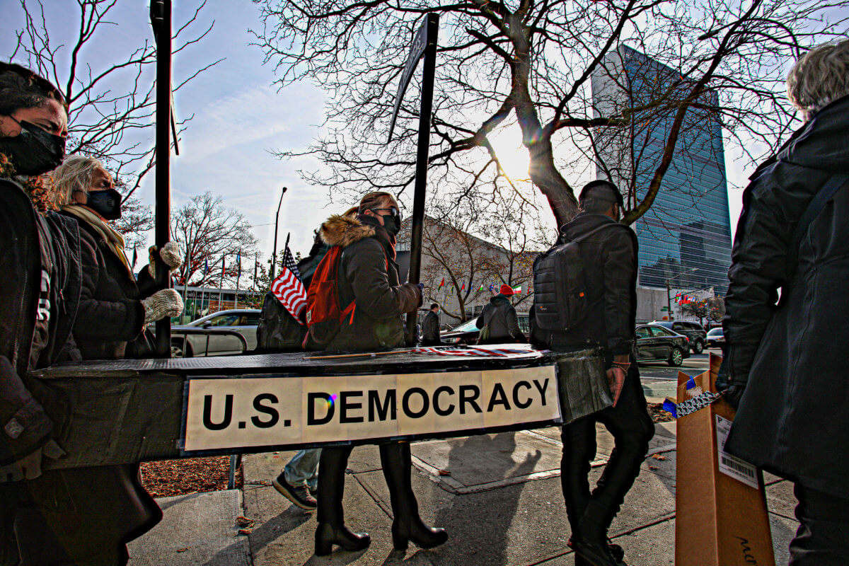 'Everybody thinks it can't happen here until it does': Protesters outside UN hold fake funeral for democracy, voting rights in America 6