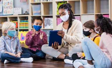 Preschool teacher, students in class, wearing masks