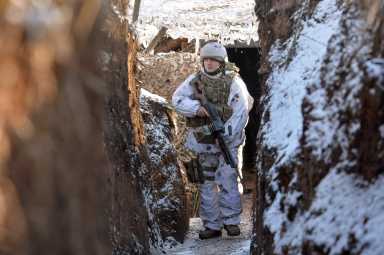 FILE PHOTO: Ukrainian service members guard the area near the line of separation in the Donetsk region