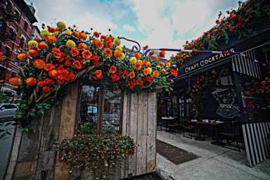 A flower-draped outdoor dining shed at French bistro Loulou.