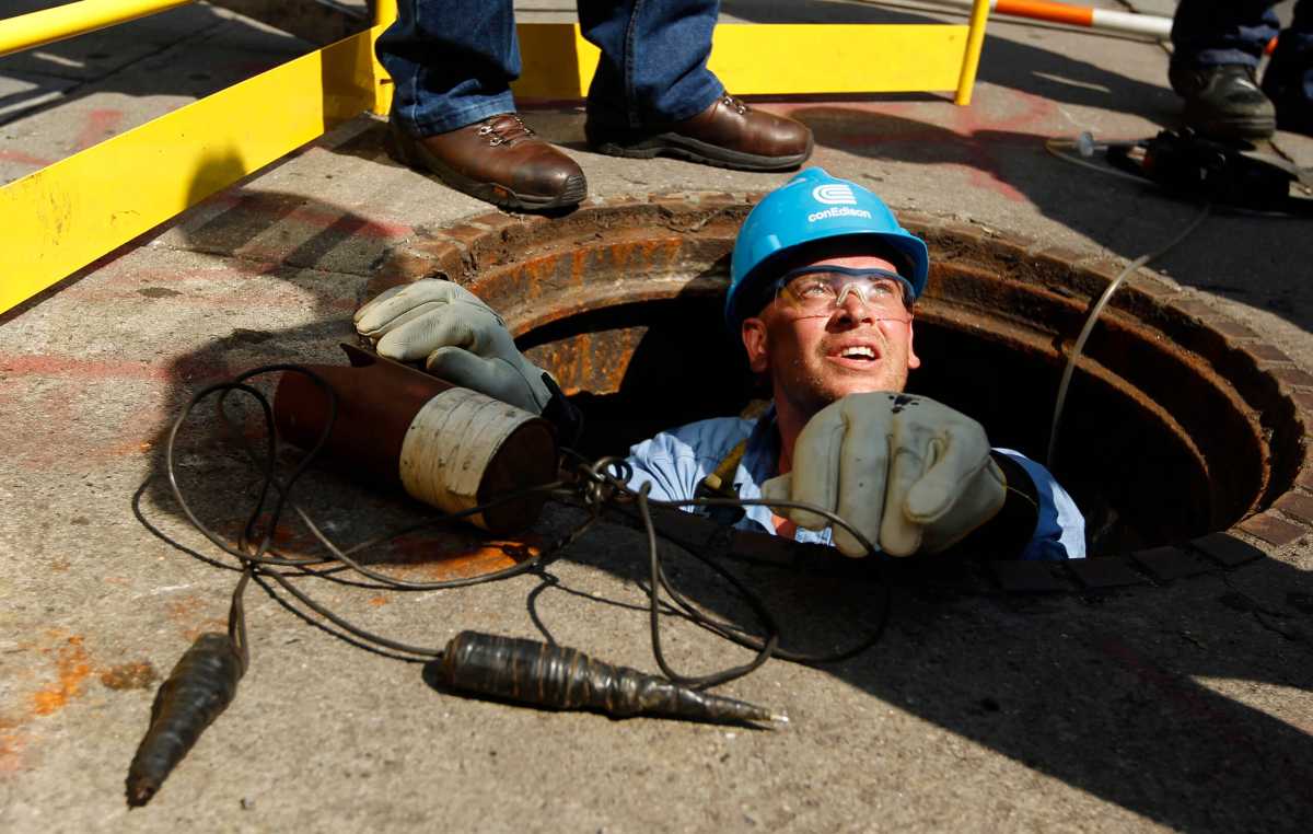 A Con edison worker in a manhole during power outage