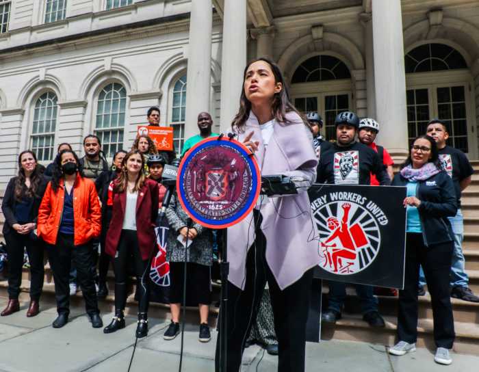woman standing at podium in front of group at city hall