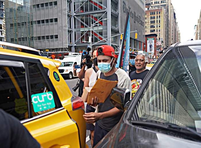 A new arrival enters an awaiting yellow cab