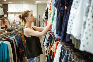 Study shows that NYC is the best city for thrifting 31 Woman looking clothes in the shopping mall, seasonal sale or thrifting concept