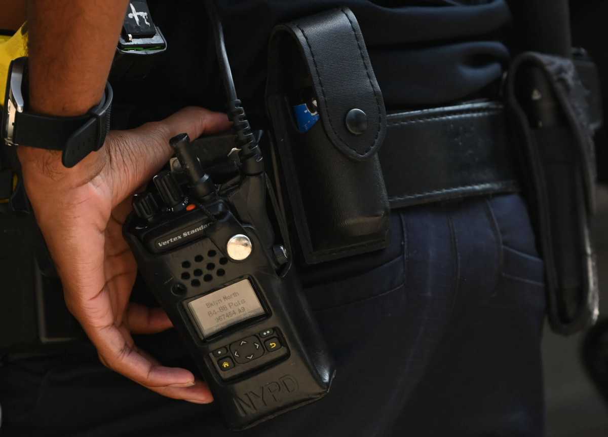 A NYPD Officer's Vertex Standard radio sits in a protective case.