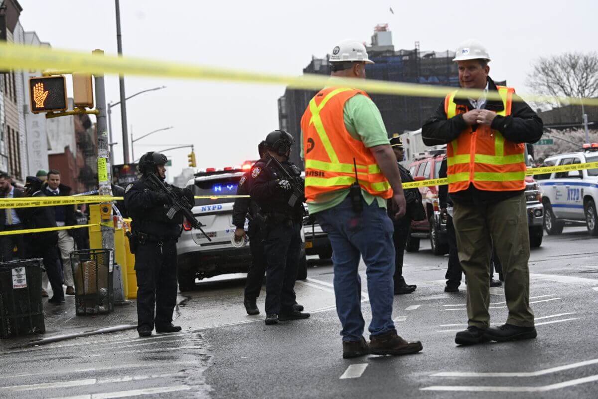 Heavily-armed NYPD officers and MTA workers on the scene of a reported Brooklyn subway shooting