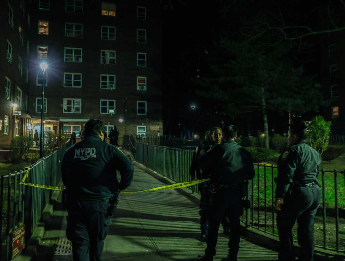 Police investigate the scene at Harlem's St. Nicholas Houses, 200 West 131st St., Sunday evening, March 26.