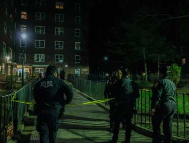 Police investigate the scene at Harlem's St. Nicholas Houses, 200 West 131st St., Sunday evening, March 26.