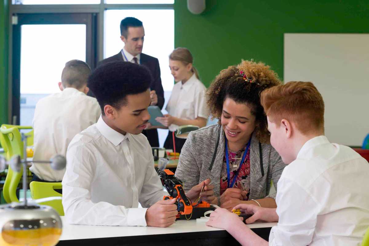 Teacher with students in charter school classroom