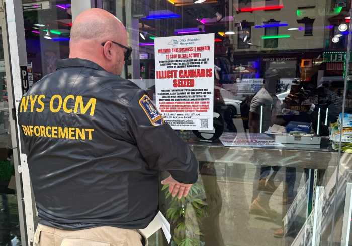 New leadership at NY Office of Cannabis Management aims to fix botched legal marijuana industry rollout 4 An Office of Cannabis Management enforcement officer posts a sign after a store was raided in Manhattan for illegal pot sales on June 7, 2023.