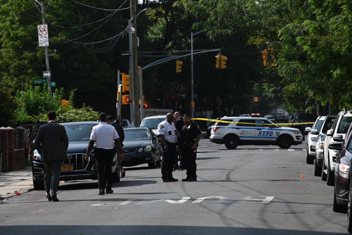 Police at the East Flatbush crime scene where a man was shot in the leg