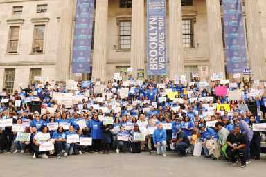 Members and staff get together for a photo after a fair contract rally