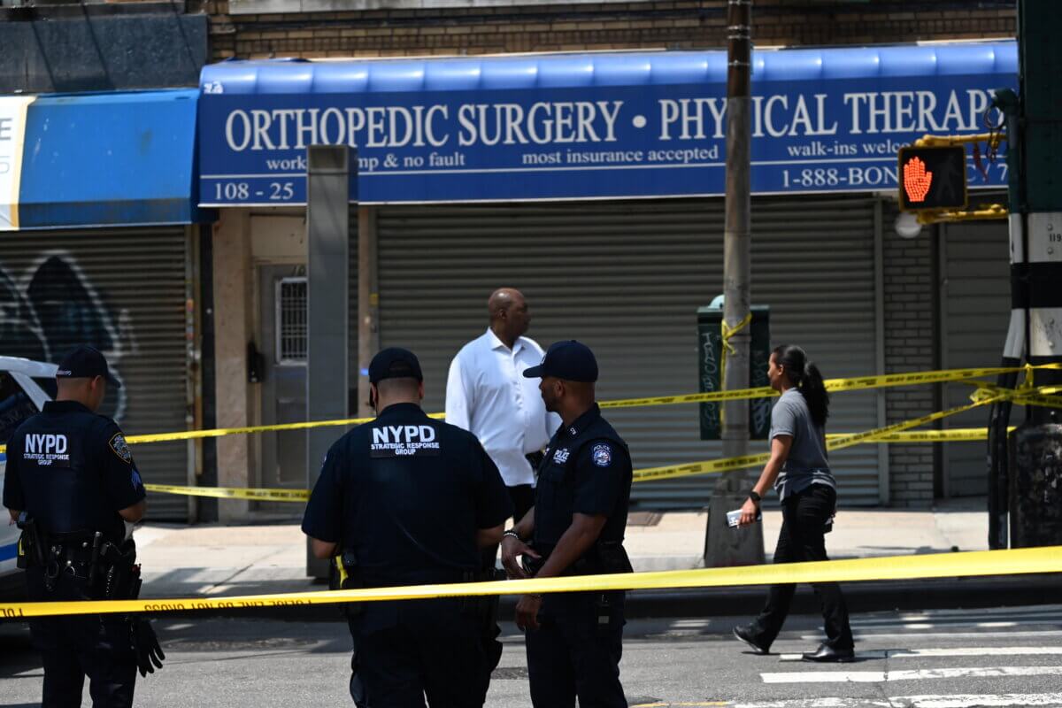Police officers at Queens shooting spree scene