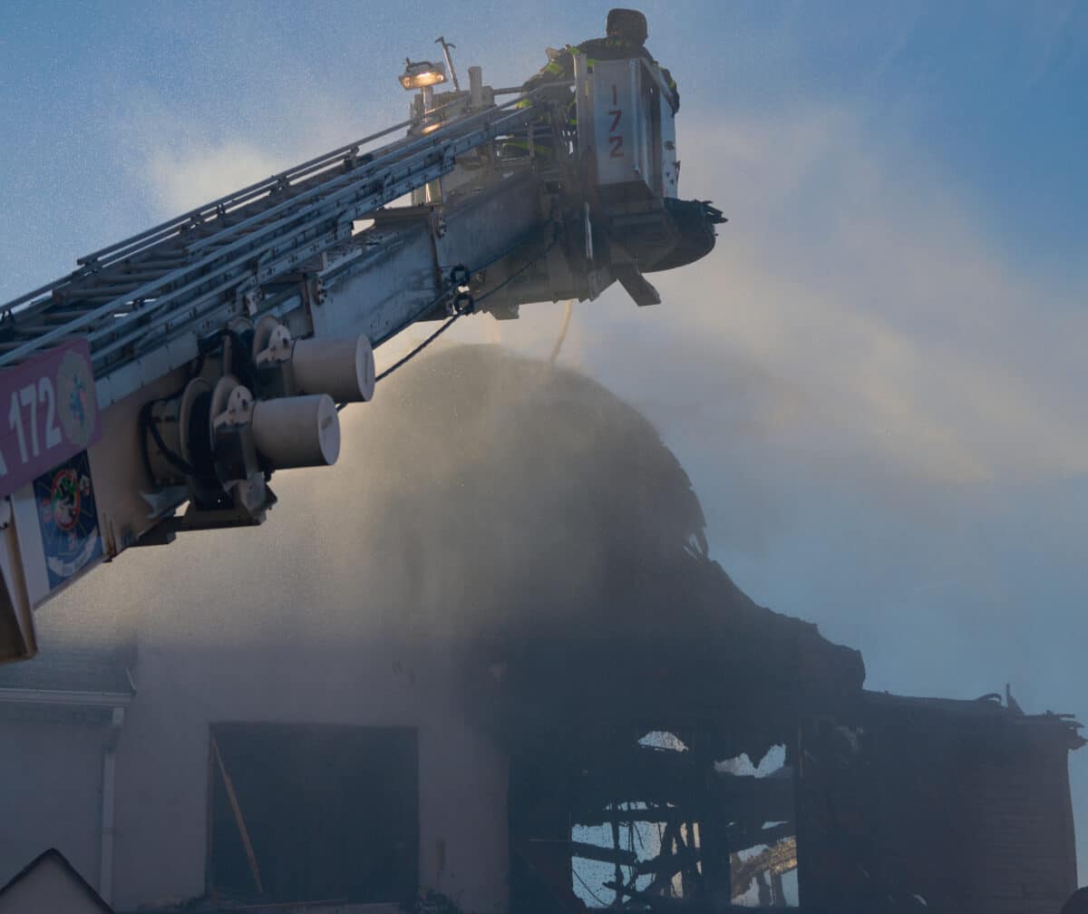A Firefighter from Rescue Company 2 is covered in dirt and grim after operating at a two alarm fire at 1424 East 2nd Street
