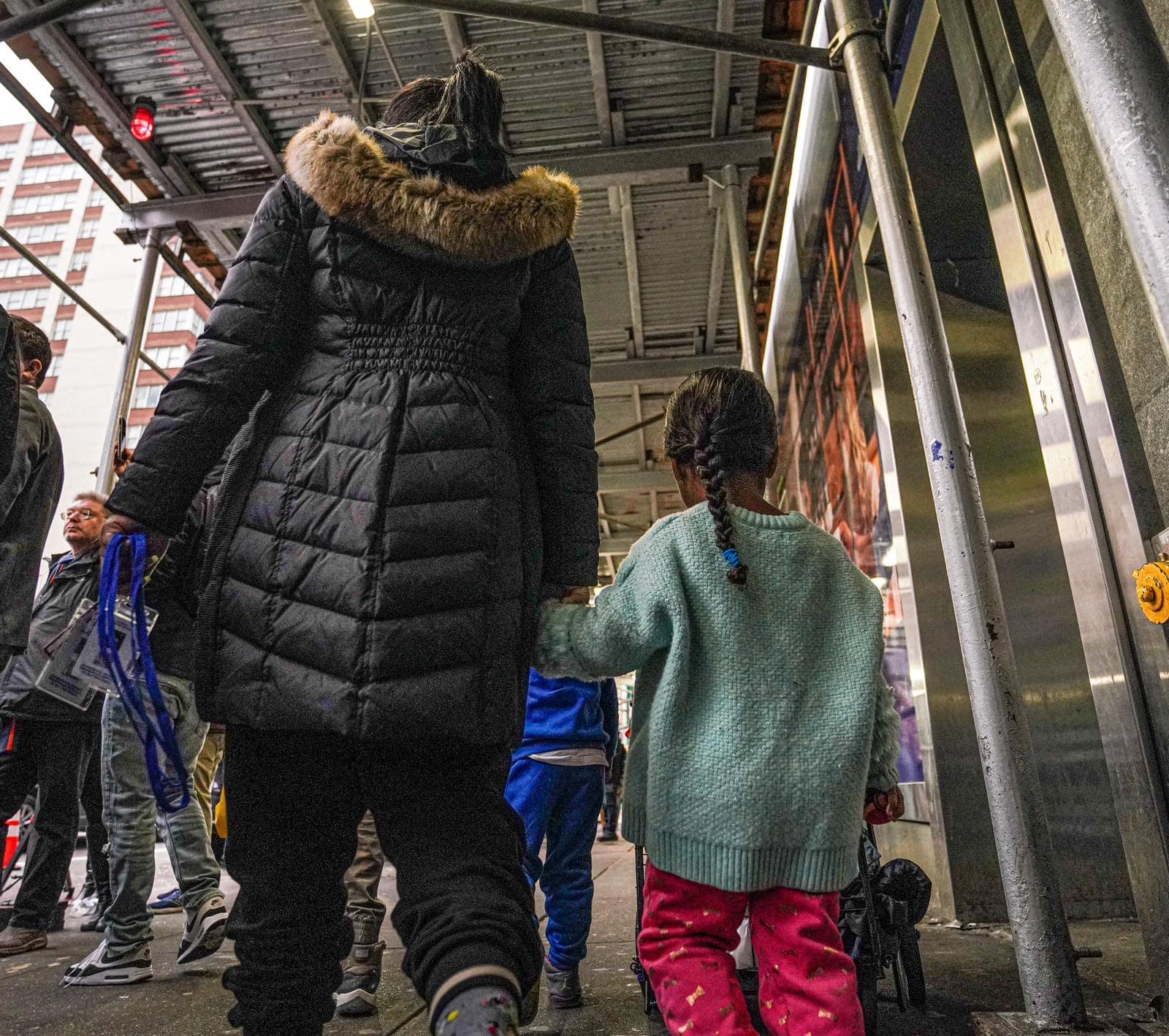 Migrant evictions begin with pregnant women, children forced out of hotel as Lander announces investigation into 60-day shelter cap 15 sullen and concerned, families wandered into an uncertain future