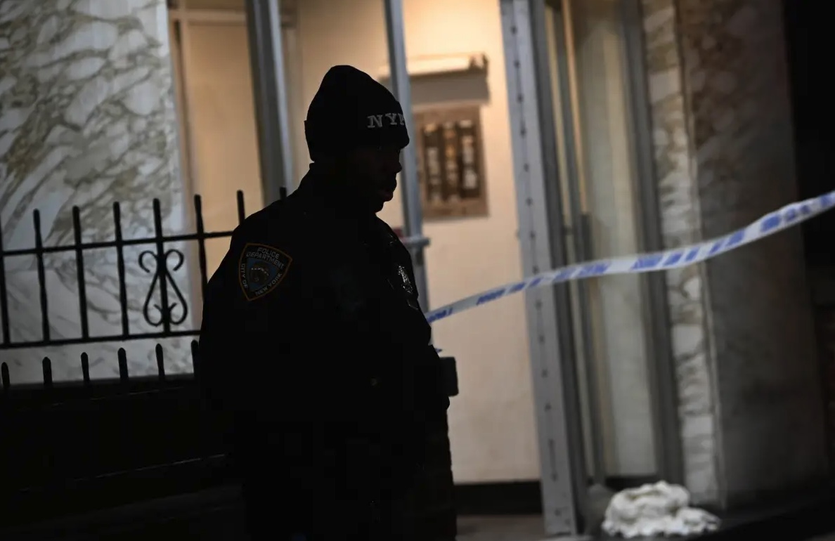 A police officer stands guard at a crime scene