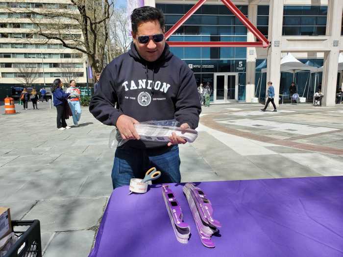 A brief history (and foretelling) of solar eclipses visible from New York City 2 Worker with eclipse glasses