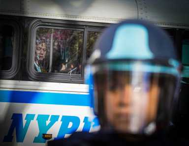Climate protesters arrested for blocking the entrance of Citigroup's Tribeca headquarters 6 A police officer in front of arrested climate protesters in Tribeca