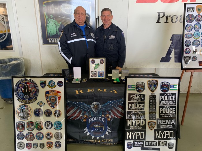 Day of remembrance honors NYPD officers killed in the line of duty 5 two police officers behind a table of medals and patches at Day of Remembrance for fallen NYPD officers