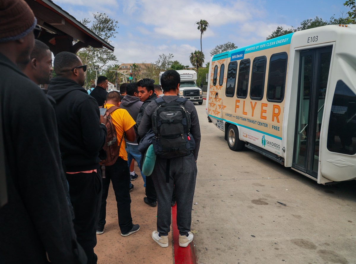 From the border to the Big Apple: One migrant's journey through hardship for asylum 8 Adoum lines up to board a bus with fellow migrants in California