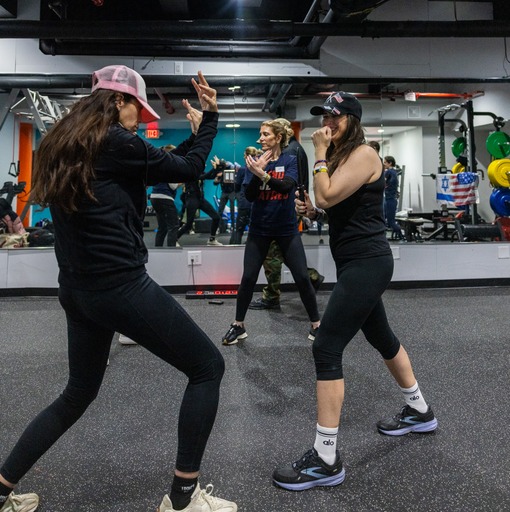 women learning self defense in a gym