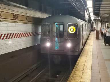 A Q train arrives at DeKalb Avenue in Brooklyn