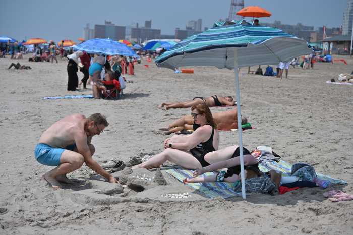 Latest NYC heat wave: New Yorkers urged to conserve energy as temperatures will feel like over 100 degrees this week 4 Man builds sandcastle on NYC beach during heat wave
