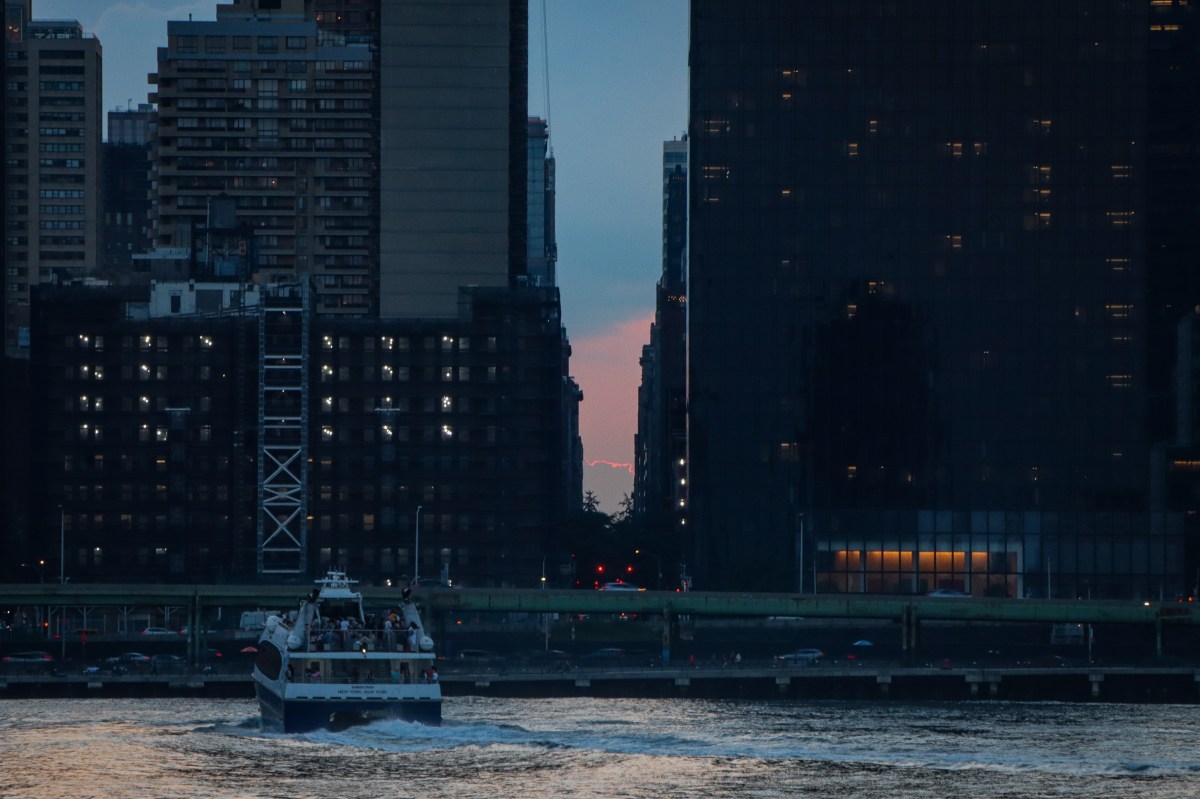 The sun sets on Manhattanhenge 2024 with cloud coverage obstructing the view 3