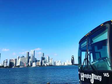 Rolling Strong for 50 Years: Hampton Jitney Adds Hudson Yards Pickup for East End Travel 32 hampton jitney with NYC skyline in distance