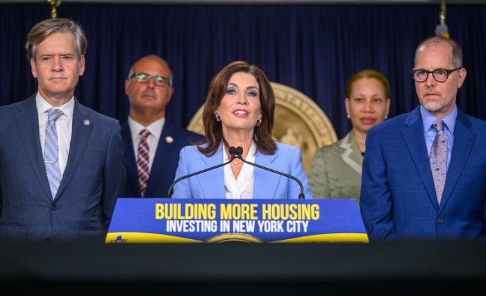 executives in suits at affordable housing i NYS press conference