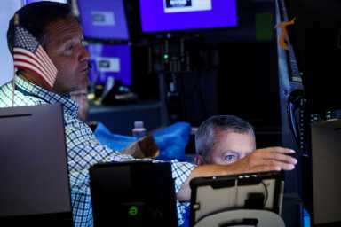 Traders work on the floor at the New York Stock Exchange (NYSE) in New York City, U.S., July 3, 2024.