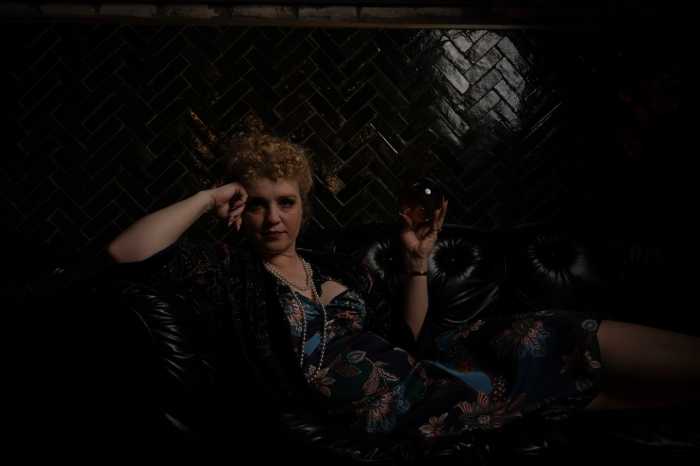 a woman in the spirits speakeasy with a crystal ball