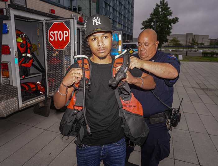 Career day at the Queens police academy brings 1,000 NYPD interns in for a look at job options 5 A police officer and a young boy