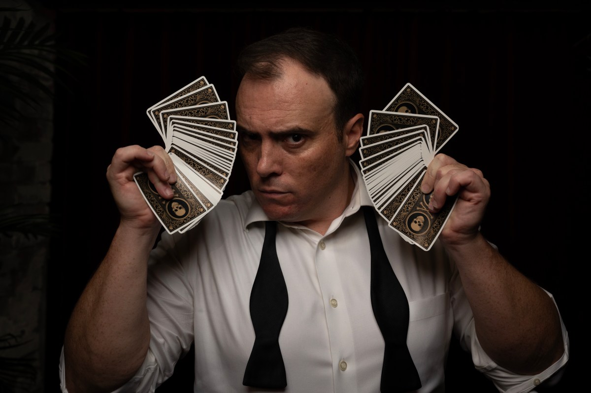 Immerse yourself in the supernatural at The Spirits' Speakeasy this fall 2 a man holding up playing cards