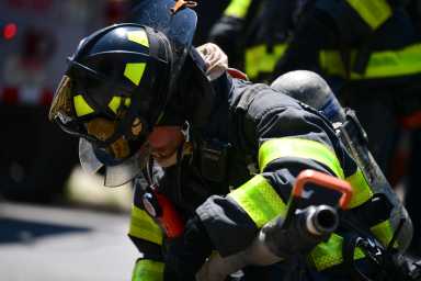 Firefighter takes a break from blaze in Sunset Park on August 10. (Photo by Todd Maisel)