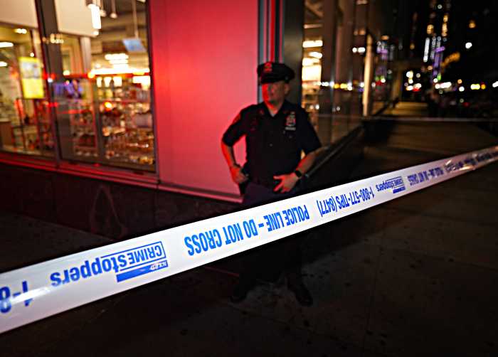 Double shooting in Manhattan leaves man dead, cops in search of suspect 4 Police at a shooting scene in Queens.