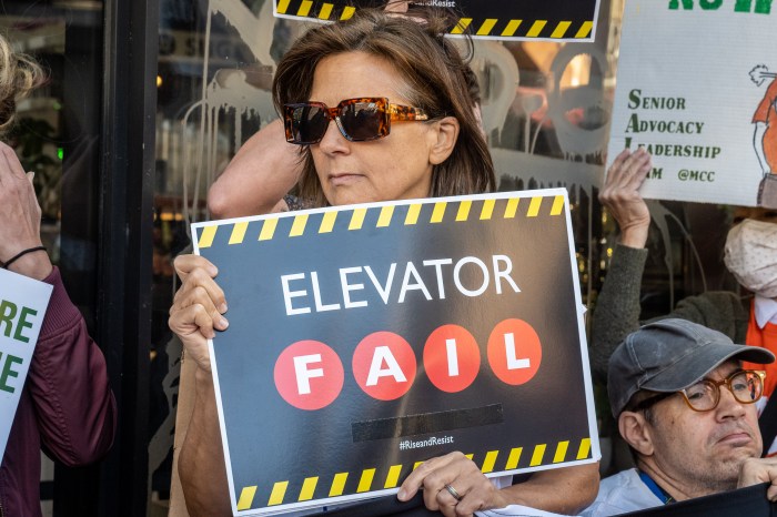 The poll results are in: Here's how New Yorkers really feel about congestion pricing 2 woman holding a sign that reads elevator fail