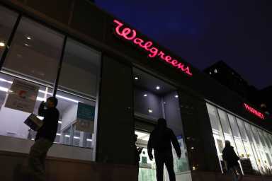 People walk by a Walgreens, owned by the Walgreens Boots Alliance, Inc., in Manhattan,