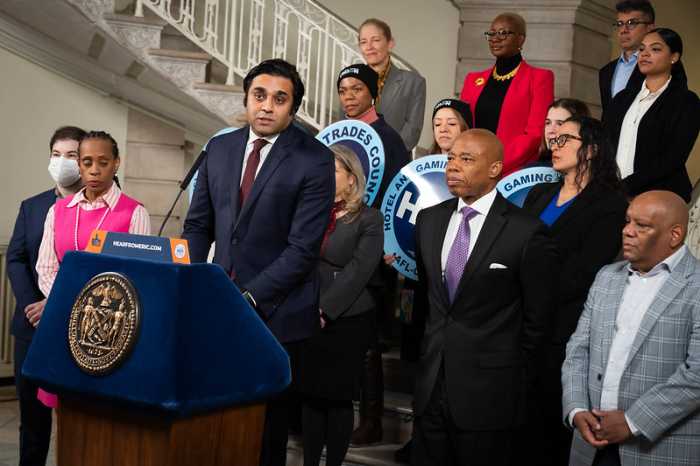 Dr. Ashwin Vasan standing with Mayor Eric Adams and other City Hall officials for a January 2024 announcement about relieving medical debt.