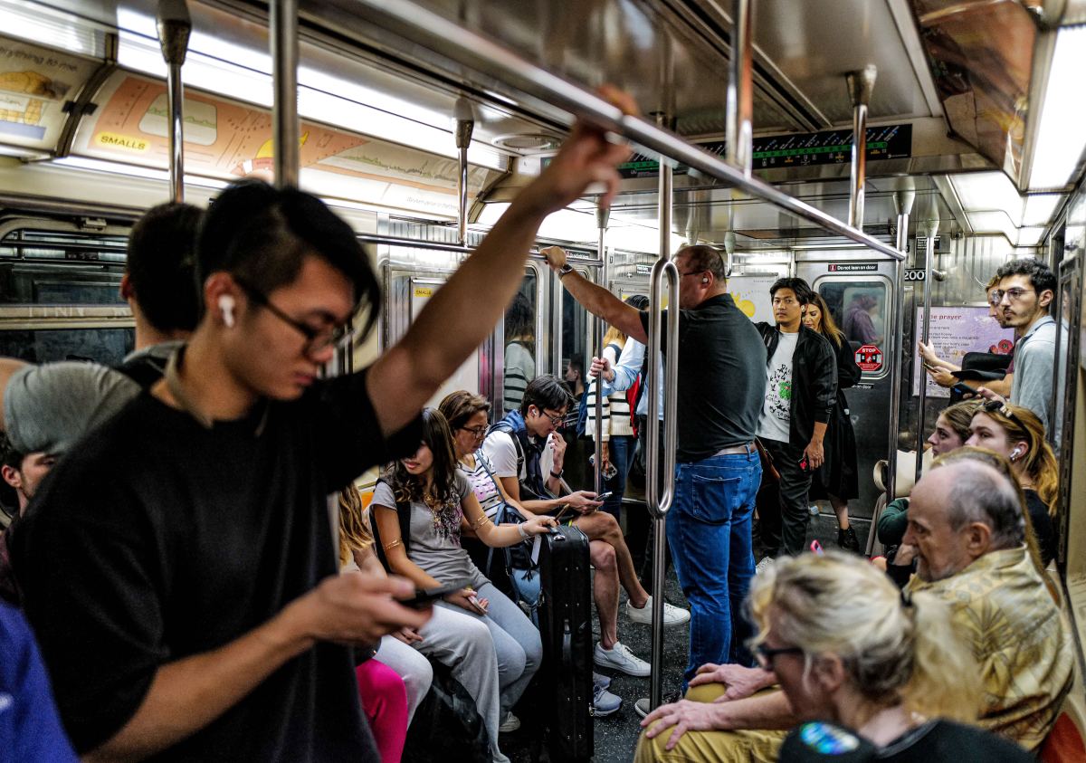 All tied up: NYC auto traffic at record highs as MTA transit ridership continues to lag pre-COVID, report finds 2 Subway riders on board a 7 train in Manhattan on Oct. 22, 2024.