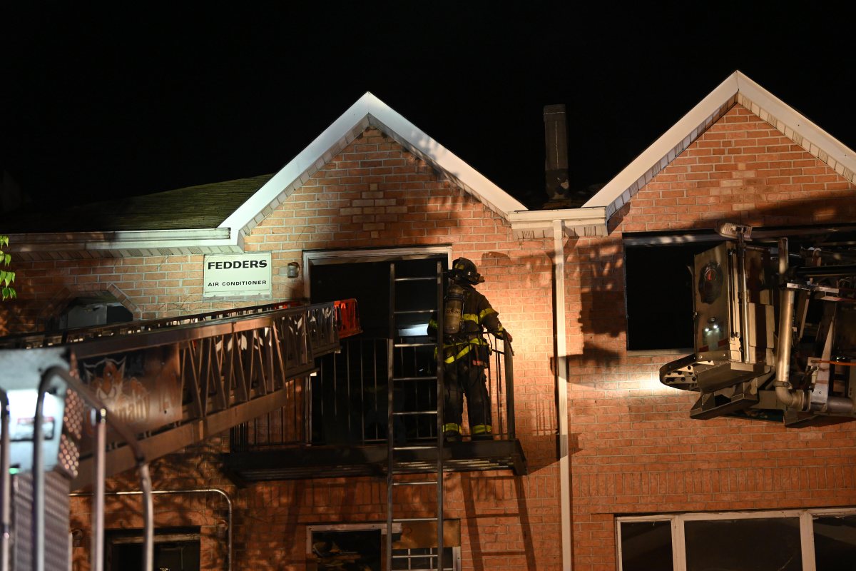 Two-alarm Queens fire rips through partially-completed homes: FDNY 2 Firefighters on ladder battle two-alarm Queens fire